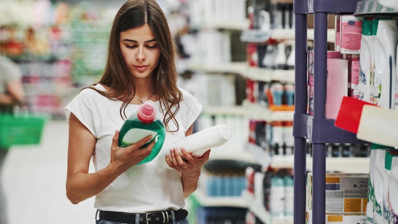 Shopper looking at back of detergent