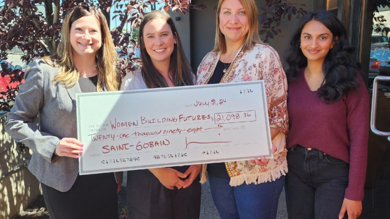 Four women shown holding a grant check from Saint-Gobain for $21,098.