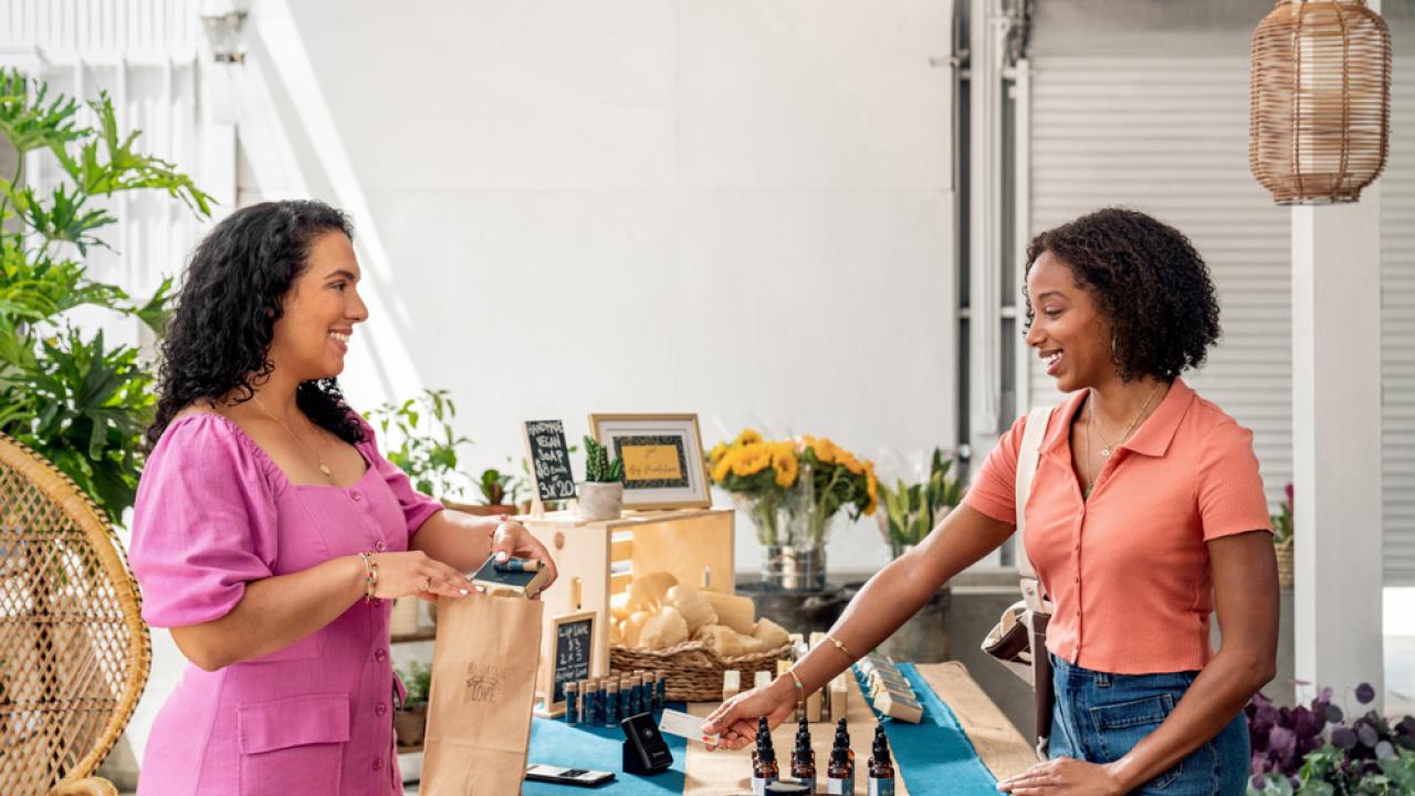 A women owned business and a customer are shown.