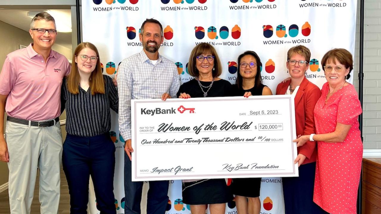 Women of the World check presentation by the KeyBank team.