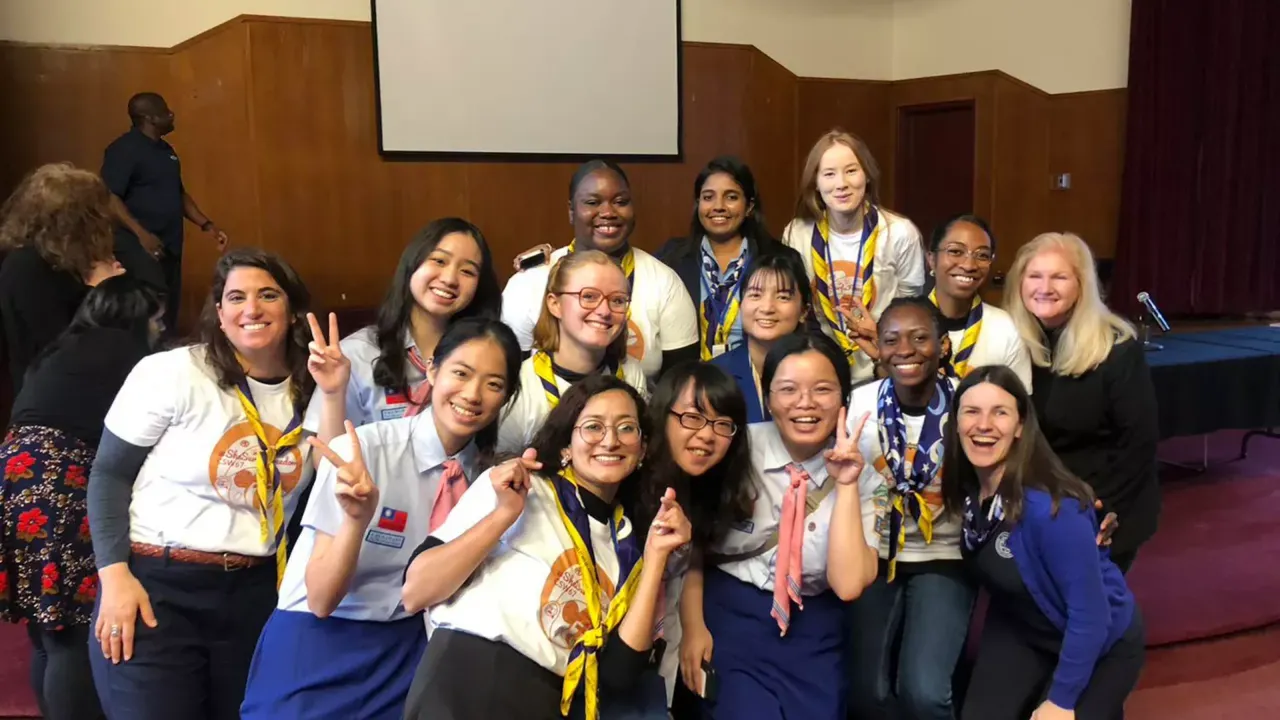 Kim Allman, h=Head of Corporate Responsibility at Gen, with a group of scout leaders from the World Association of Girl Guides and Girl Scouts