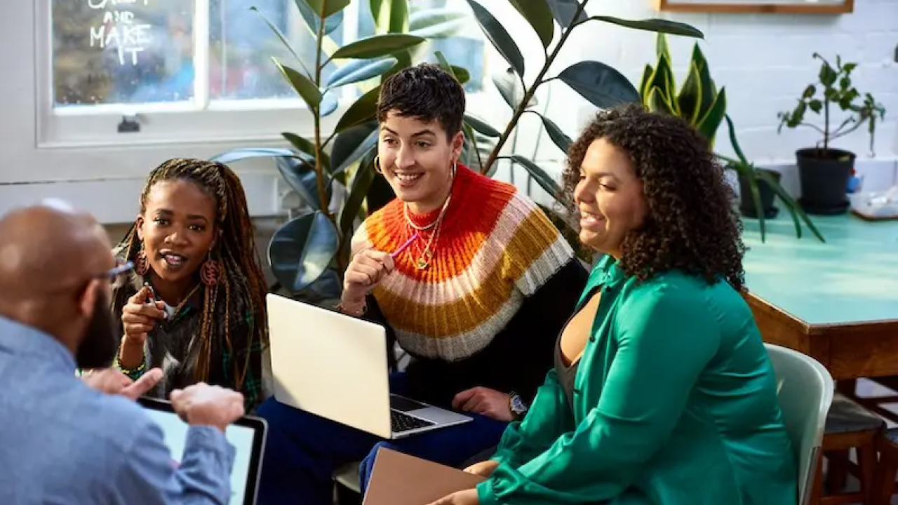Group of four people sitting and chatting.