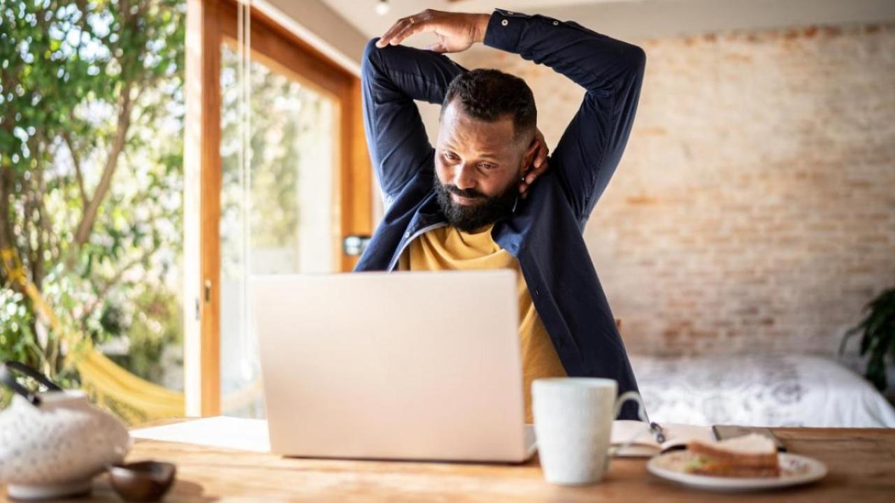 Man Stretching at Desk