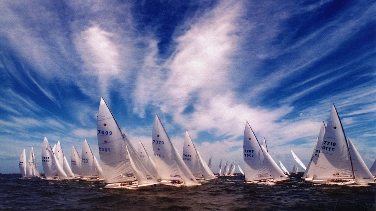 Competitors in the Star Class fleet sail across blue Biscayne Bay waters in a 1990s Bacardi Cup race.
