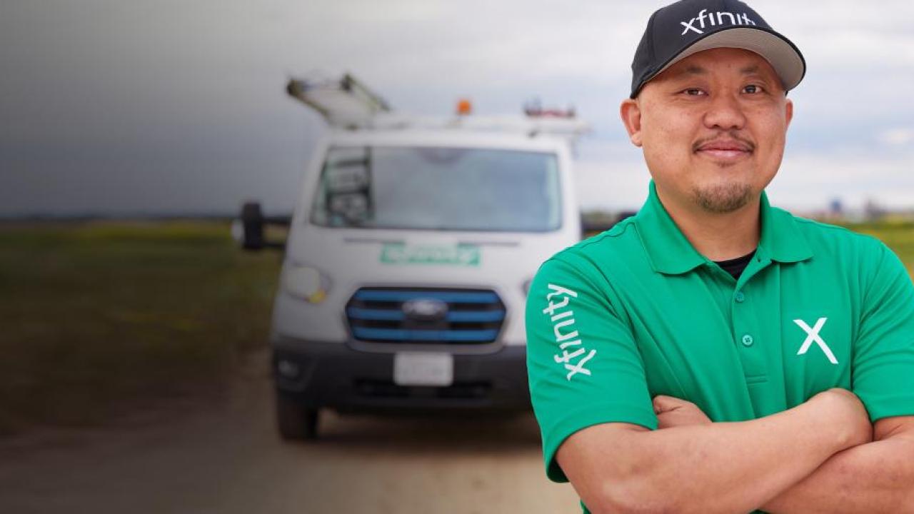 Person wearing a Xfinity t-shirt stood in front of a van