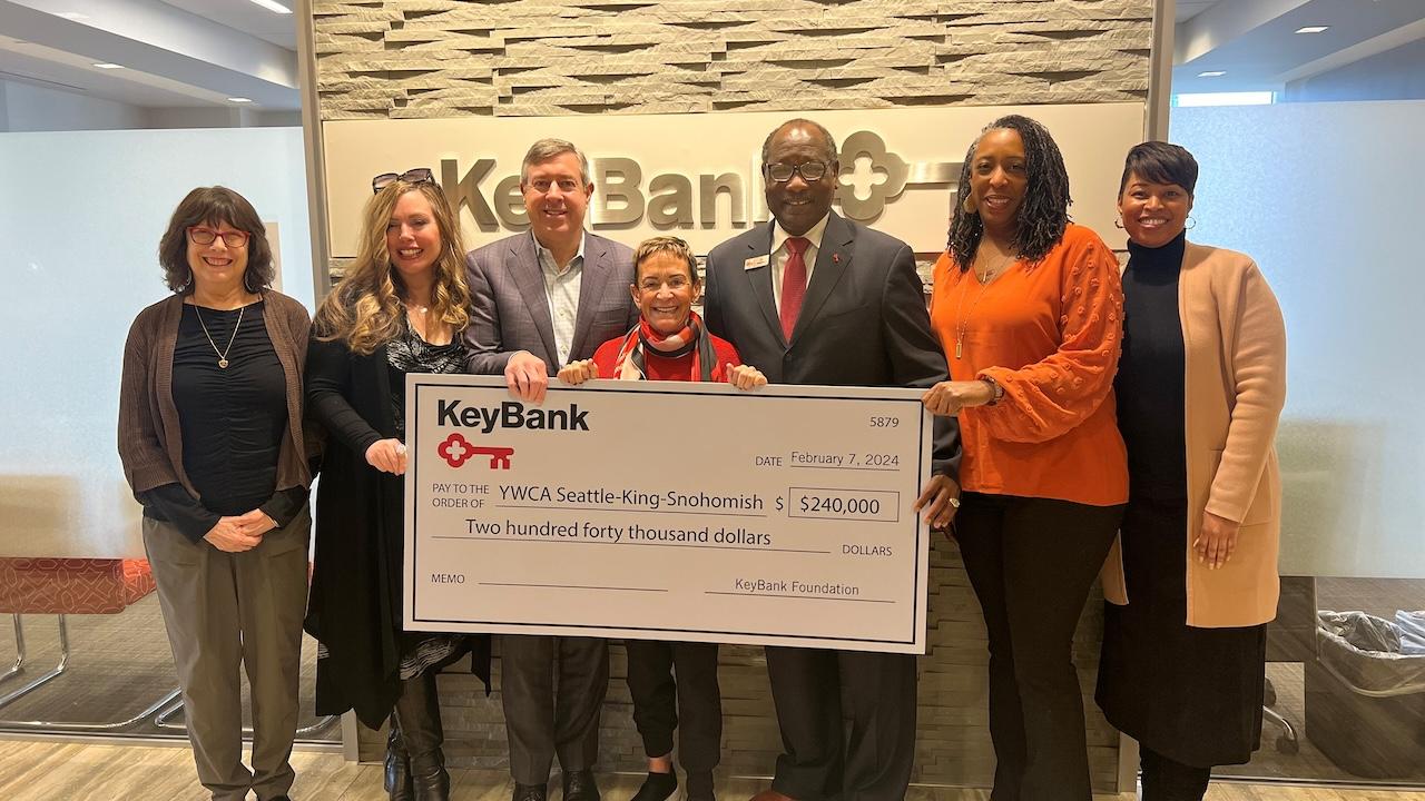 Team members from the YWCA Seattle and KeyBank shown with a $240,000 grant check.