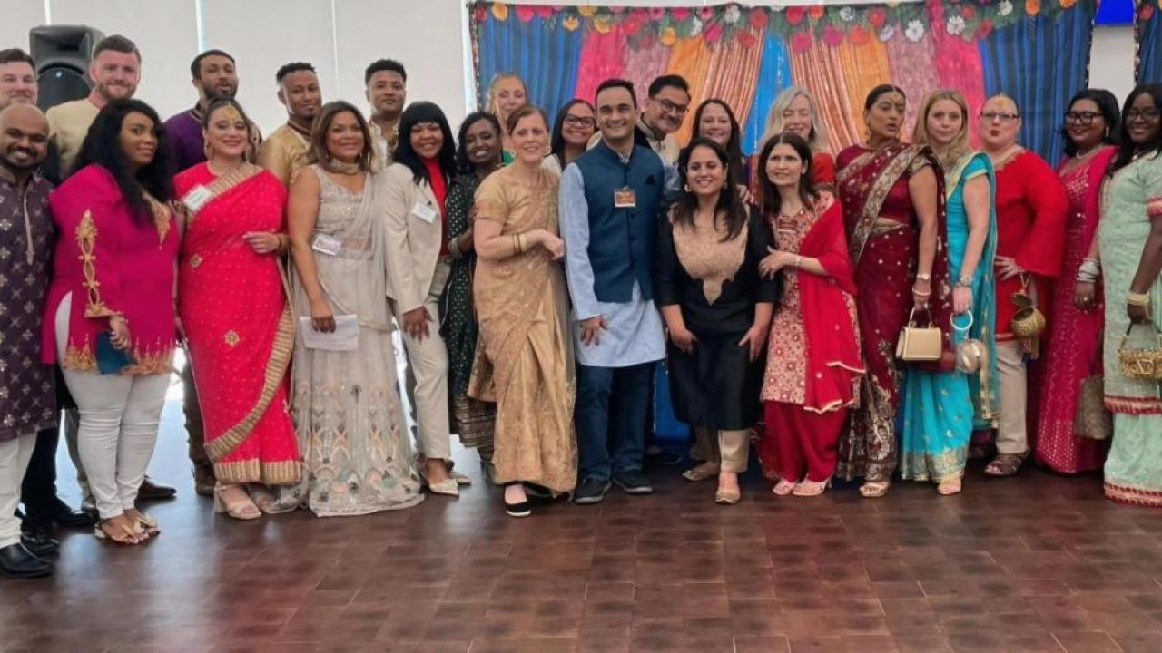 A group posed in AAPI cultural garments