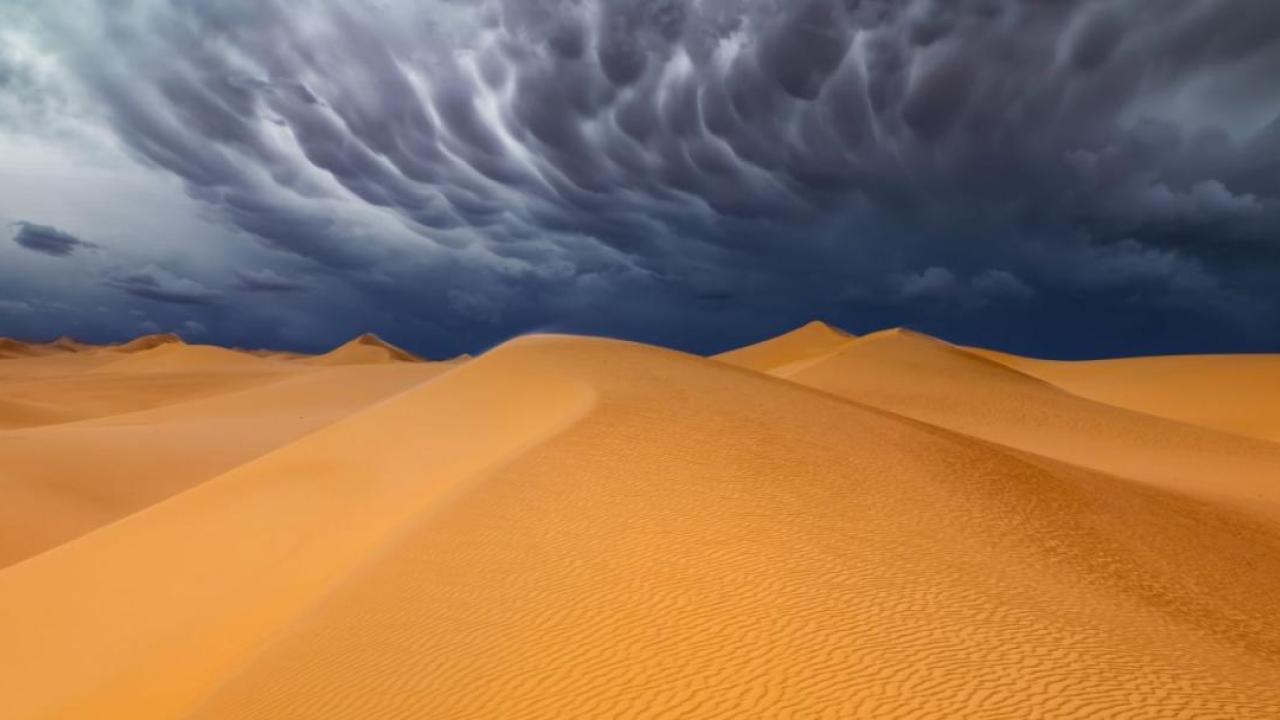 Illustration of a storm over a desert.