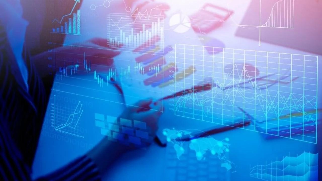 image of person looking at charts with blue overlay