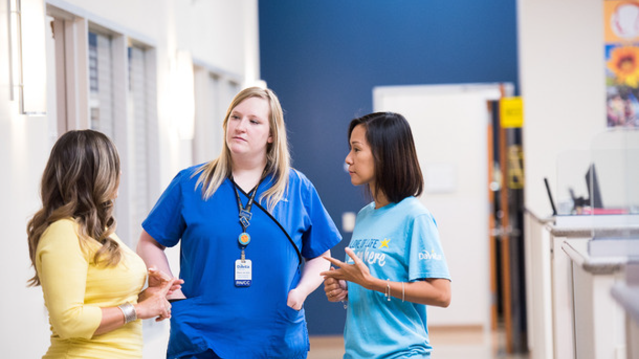 A healthcare worker talking with patients