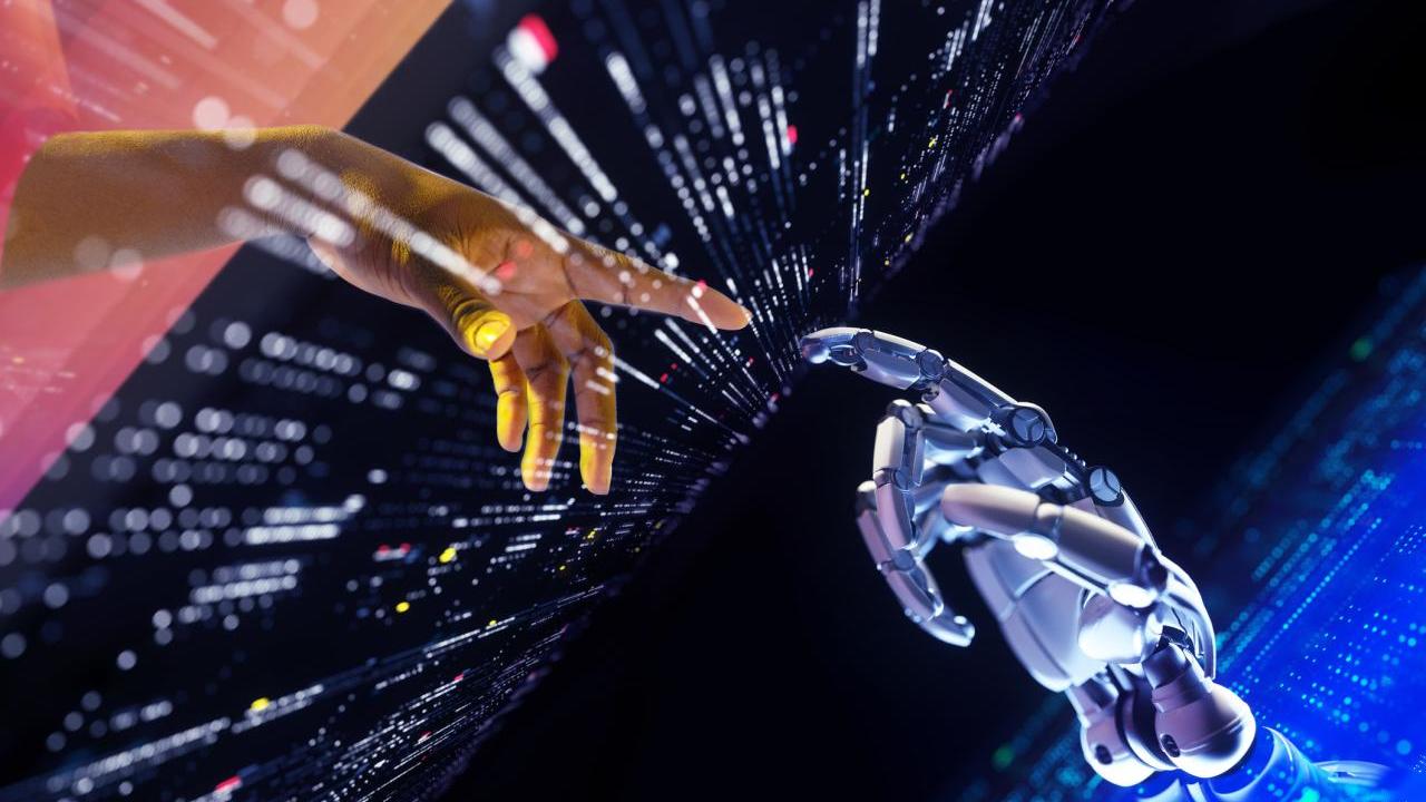 A human and robot hand with pointer fingers extended to each other. A digital screen between them.