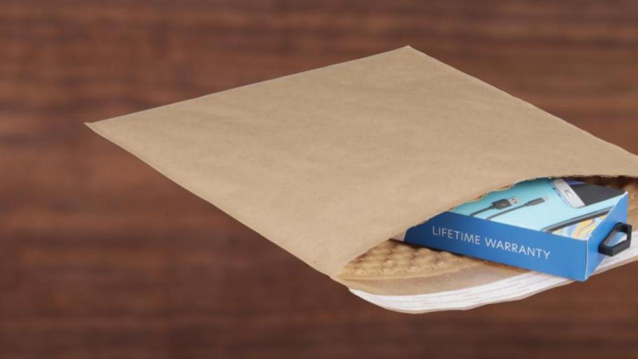 Brown paper mailing envelope with small product inside