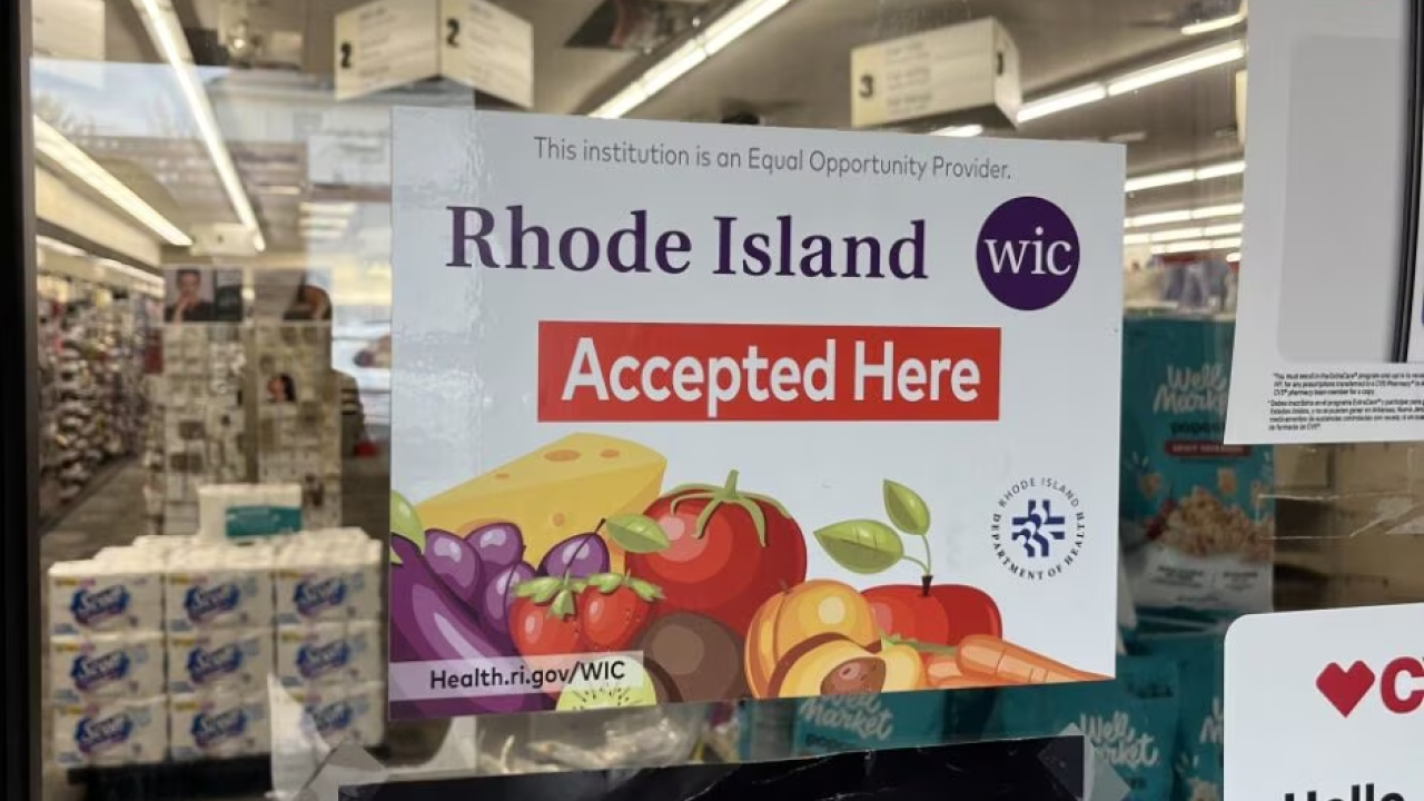 Sign reading "Rhode Island WIC Accepted Here" on a window