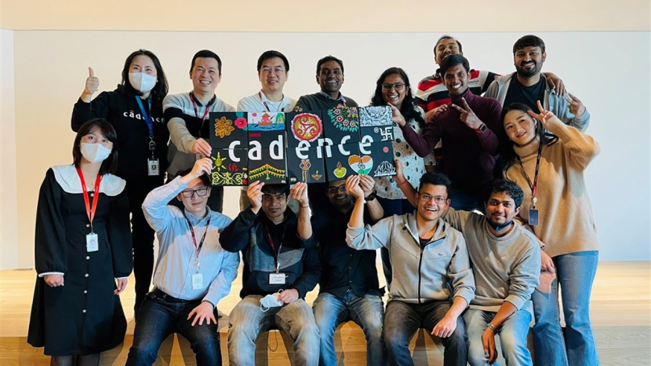 A group of employees holding up a Cadence sign