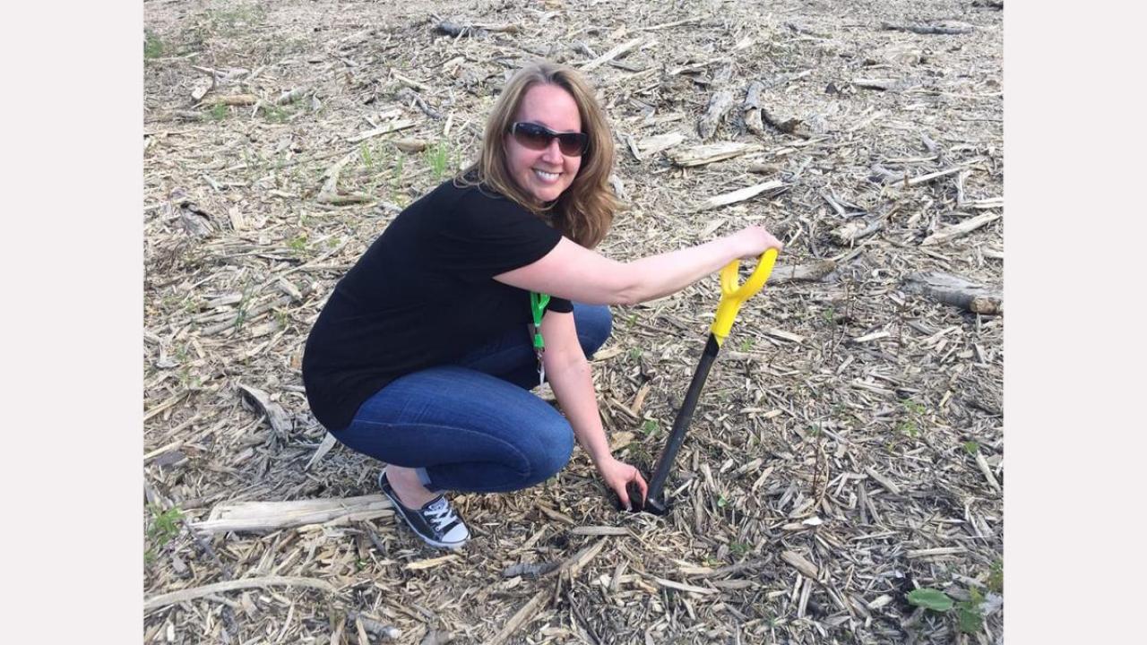 Anna planting a tree.