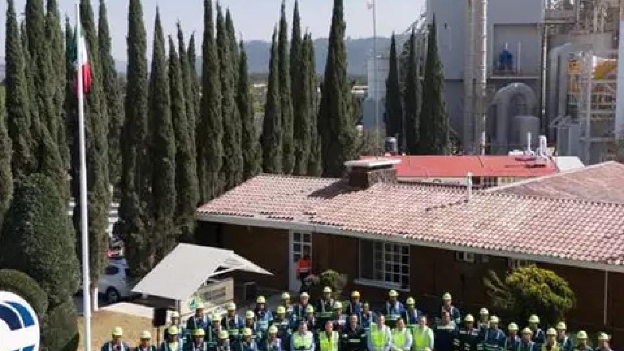 Aerial view of a group of people posed outside, next to a large "Covia" sign.