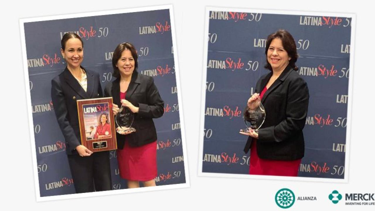 two people holding a plaque and award