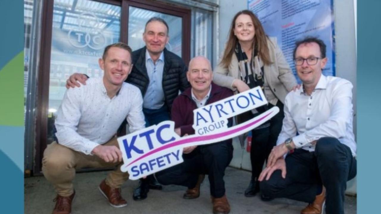 group of 5 posing with KTC Safe and Ayrton Group logos