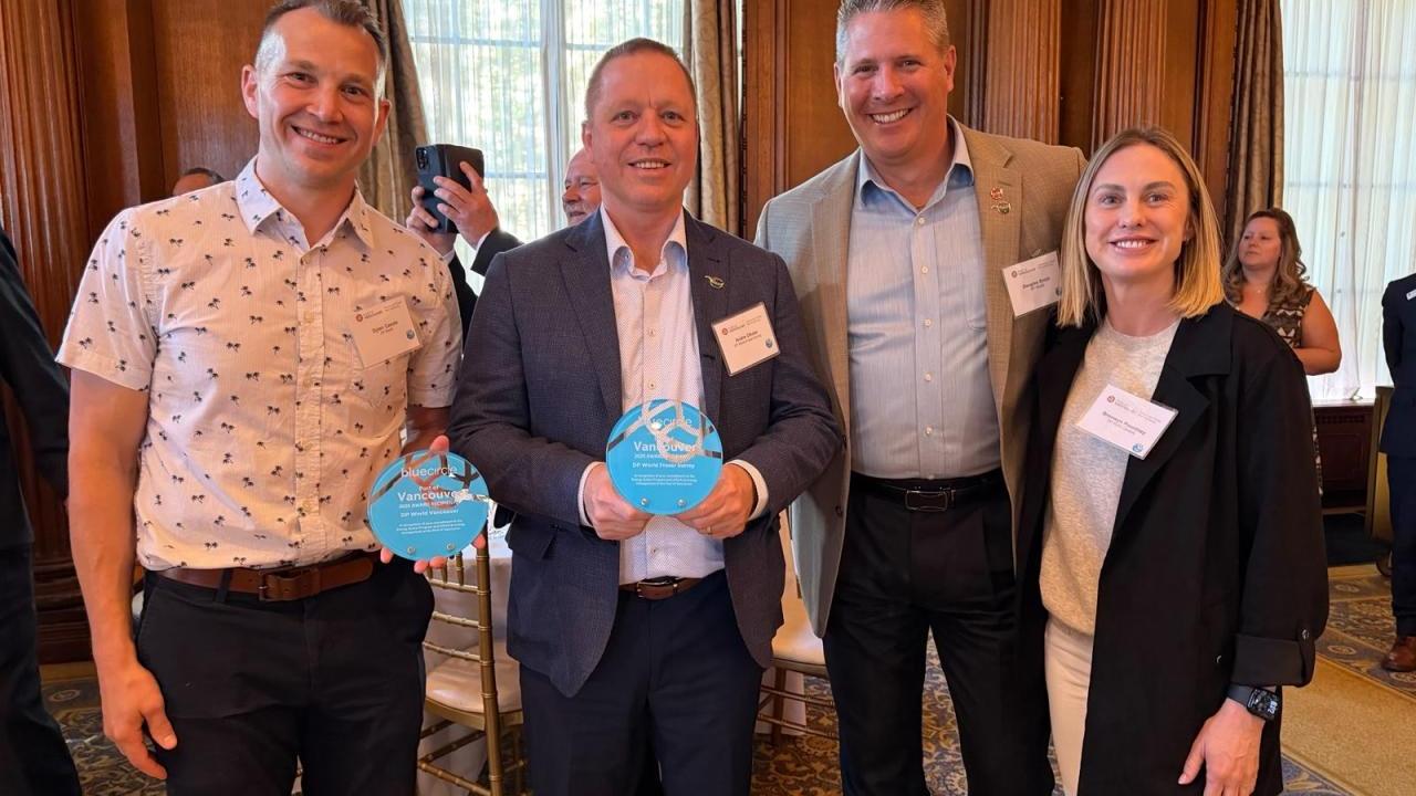 DP World recipients standing with their blue circle award 