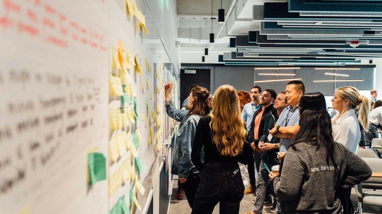 group of students standing at white board 