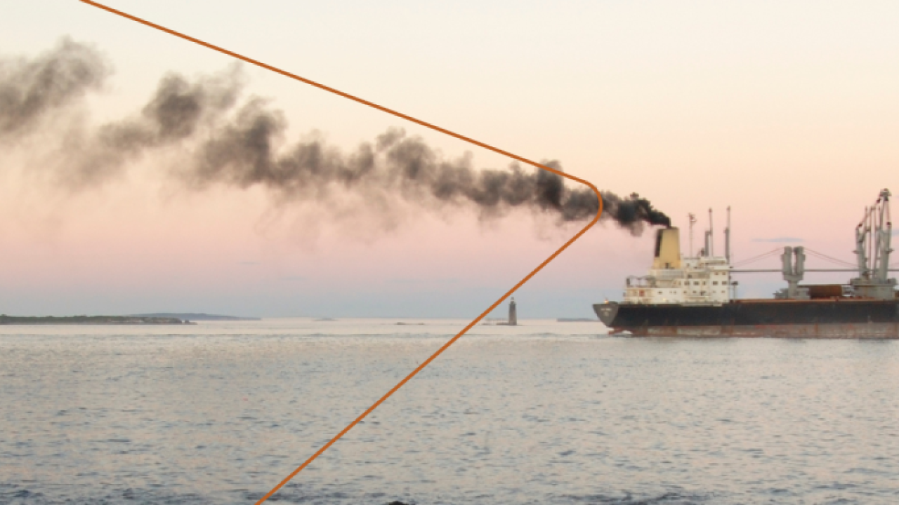 Ship with dark gray smoke coming out of smoke stack