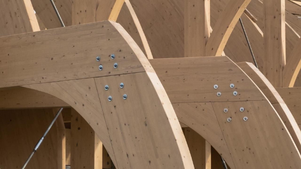 row of wood beams and rivets