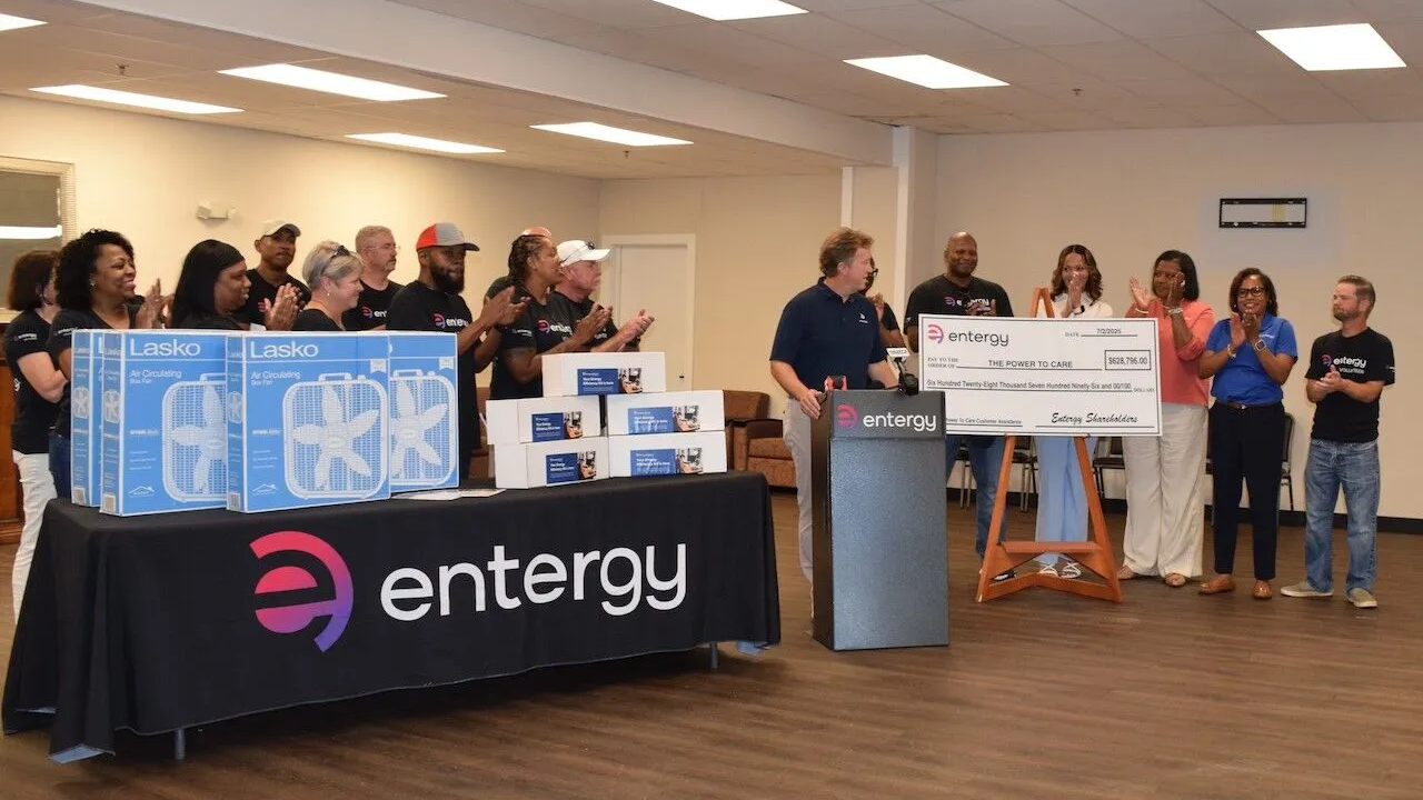 An oversized check being presented, a group clapping