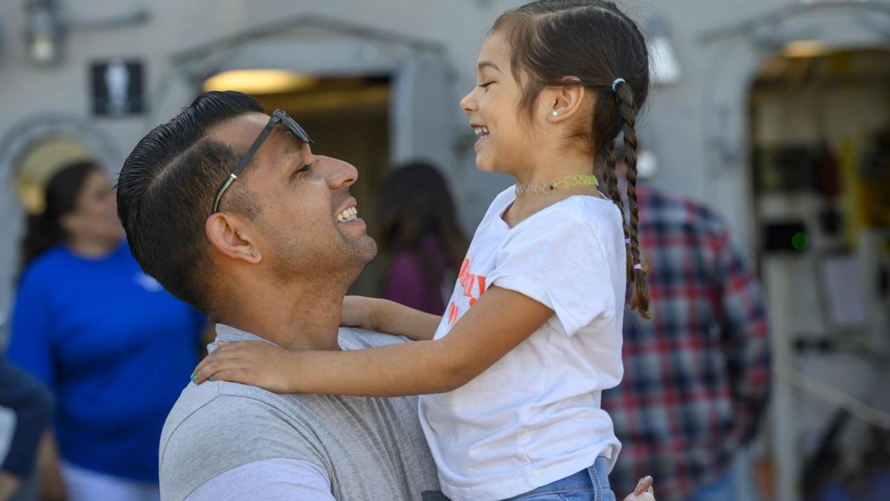 Parent holding child and smiling