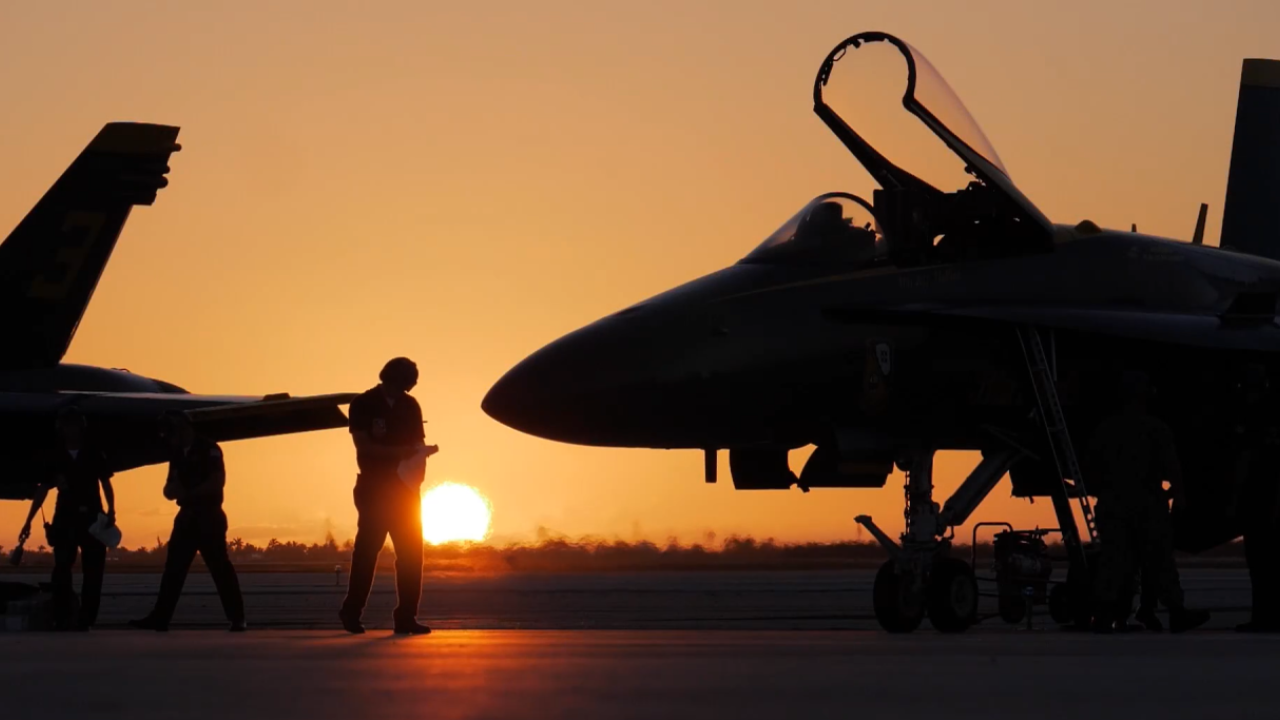 a pilot and a boeing in front of a sunset 