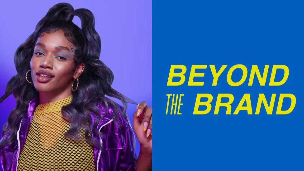 "Beyond the Brand" next to a person posing with long wavy hair.