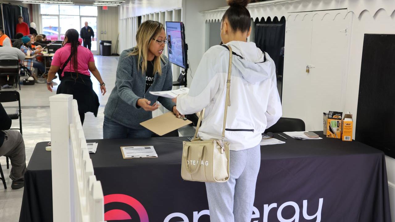 Entergy employee helping a customer at a desk