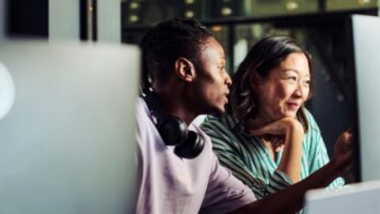 two people looking at a computer