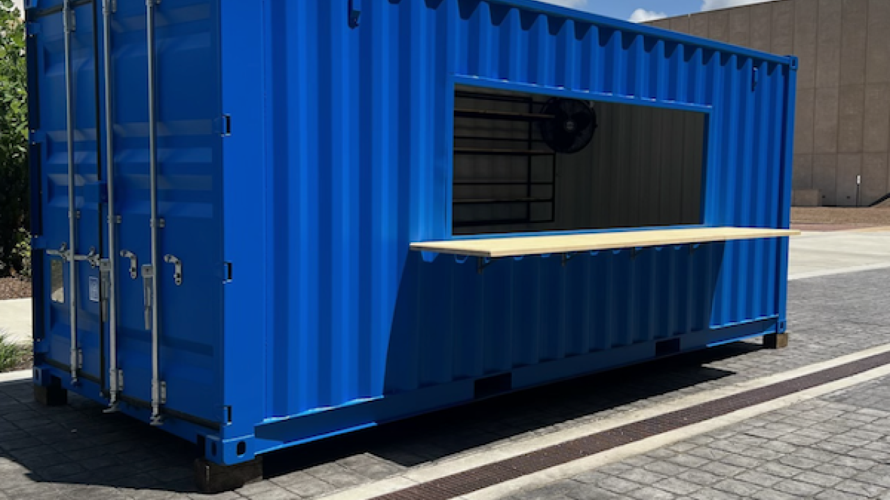Blue up-cycled shippping container mobile retail space