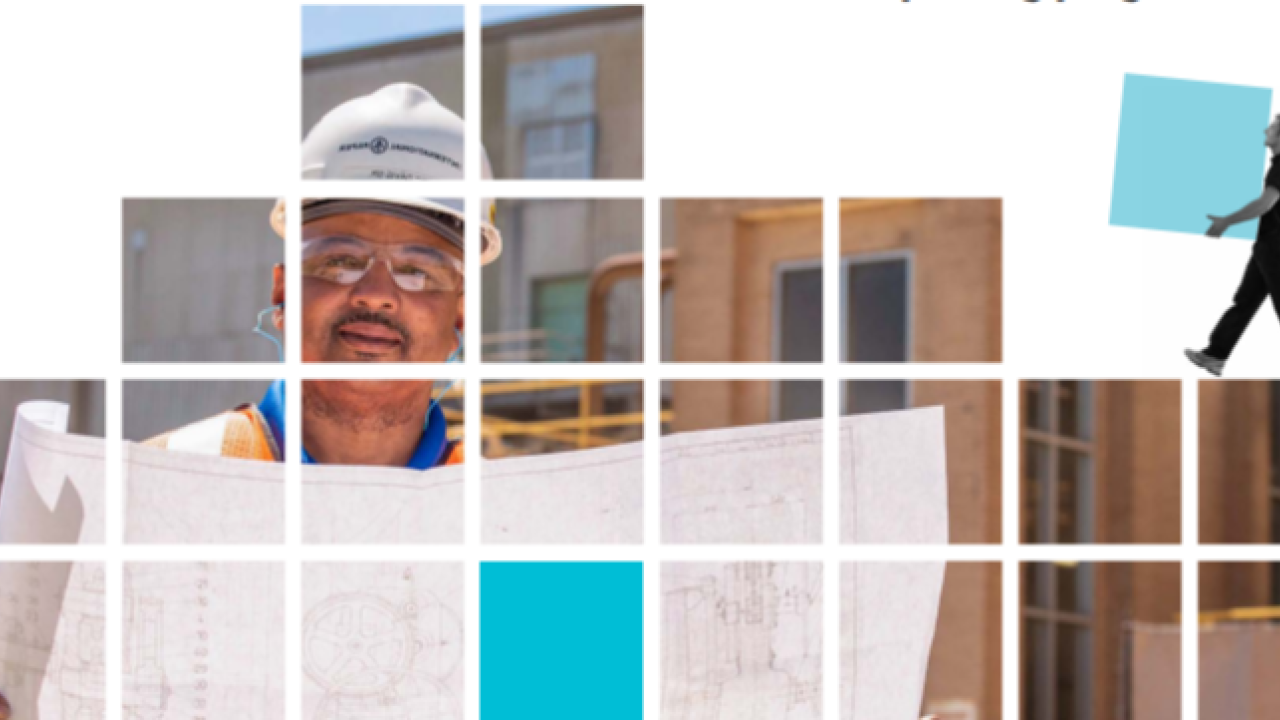 Large pixels stacked to show an image of a person reading a blueprint