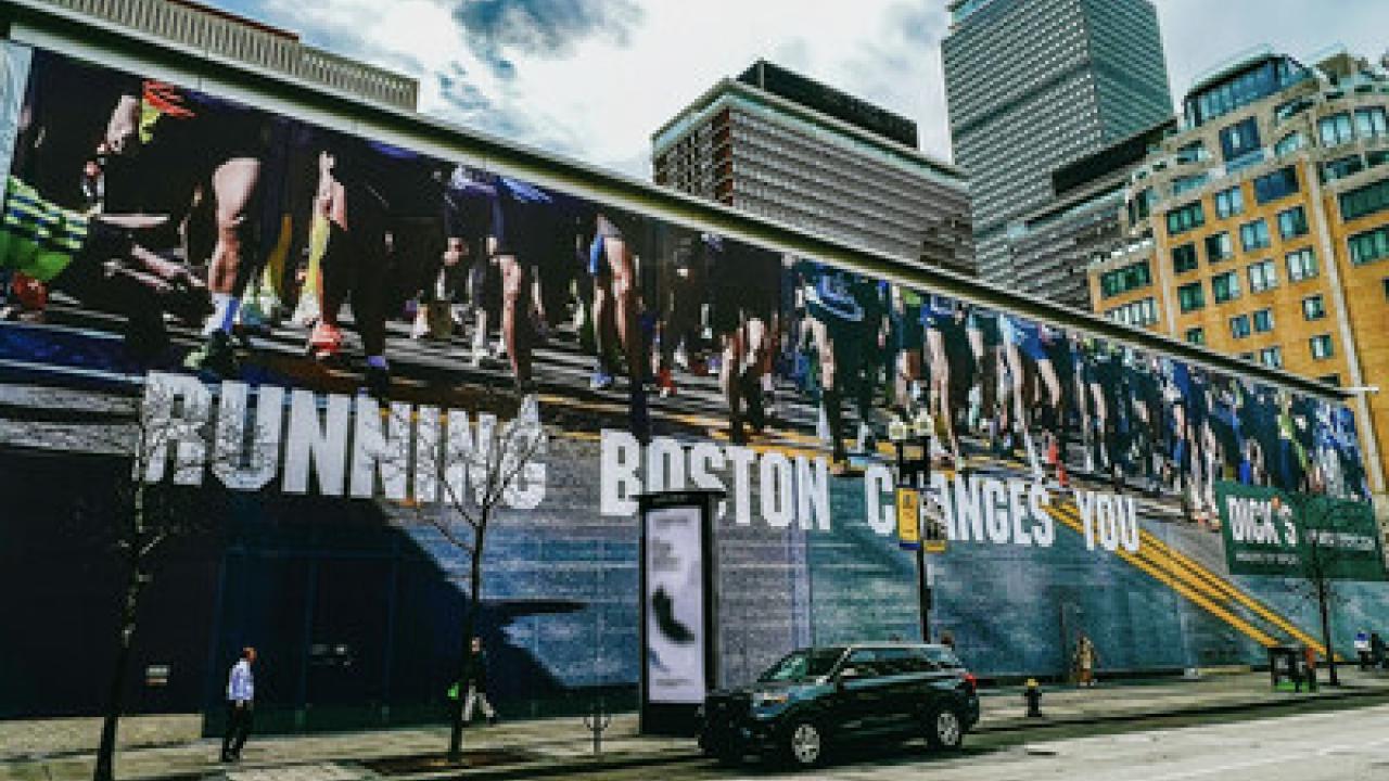 Large mural on the side of a building "Running Boston Changes You".