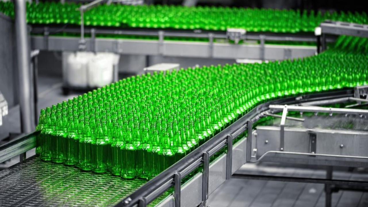 Green bottles on an assembly line