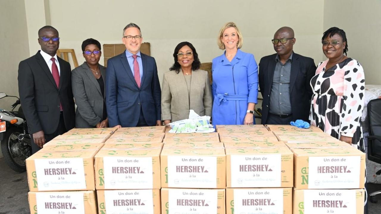 People standing behind boxes labeled "Hershey"