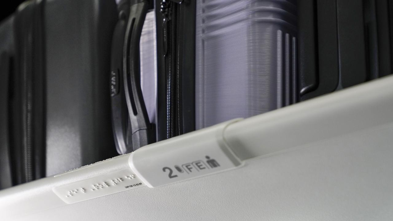 braille signage on an overhead bin