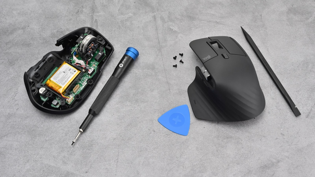 A broken computer mouse and tools
