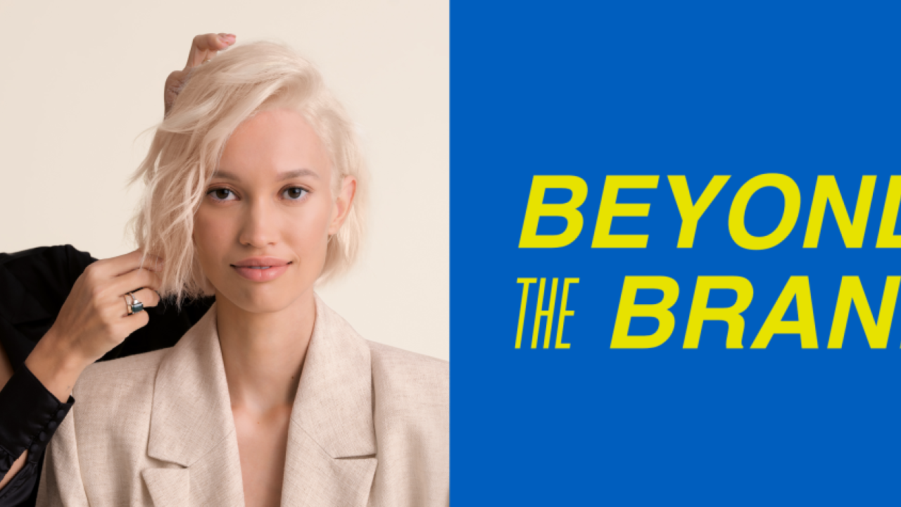 A hair stylist with a client. " Beyond the Brand"
