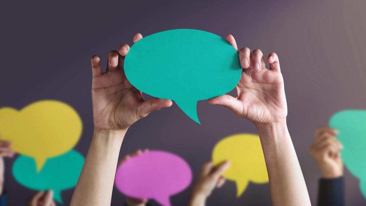 people holding up conversation bubbles 