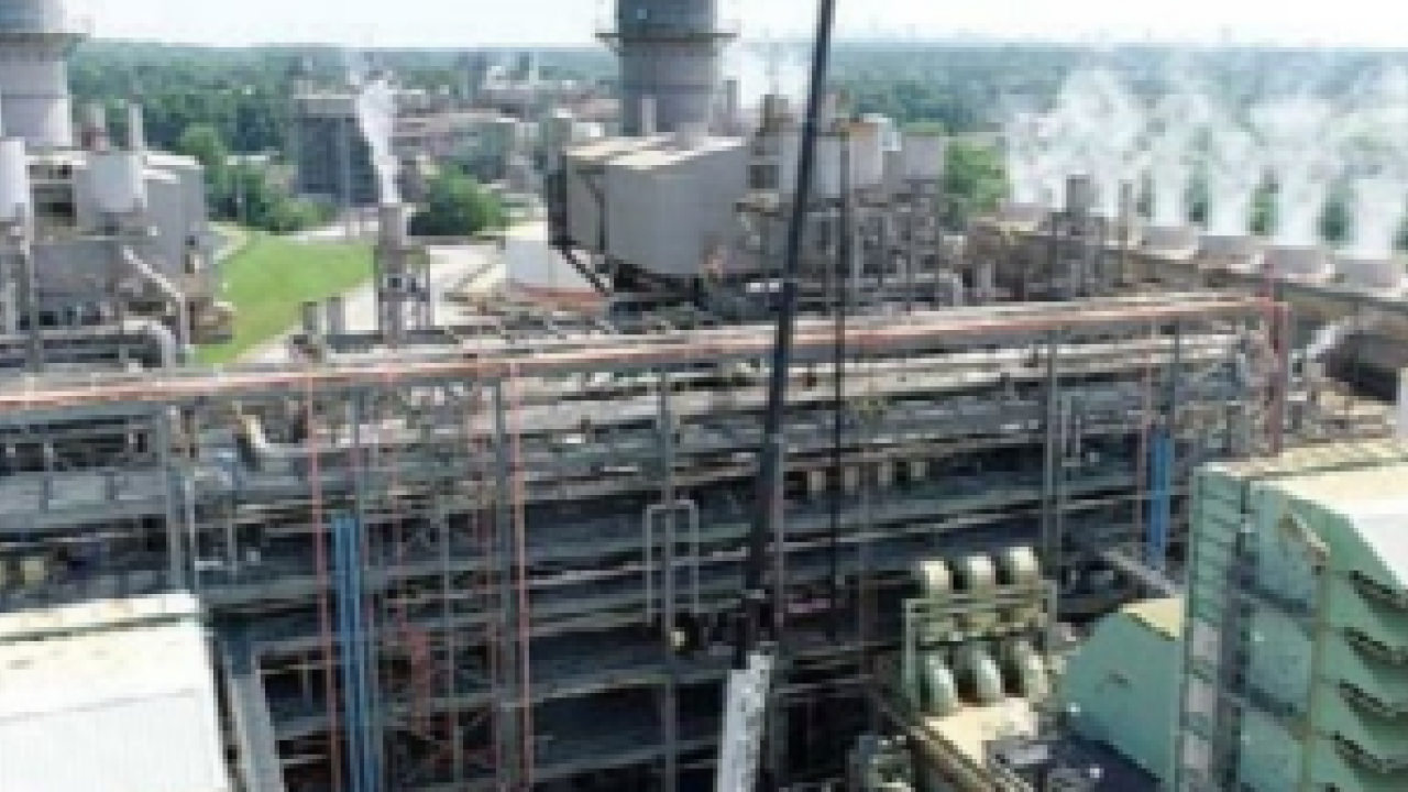 Aerial view of huge power plant, steam stacks to the right.