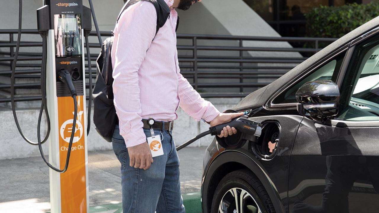 person charging a car