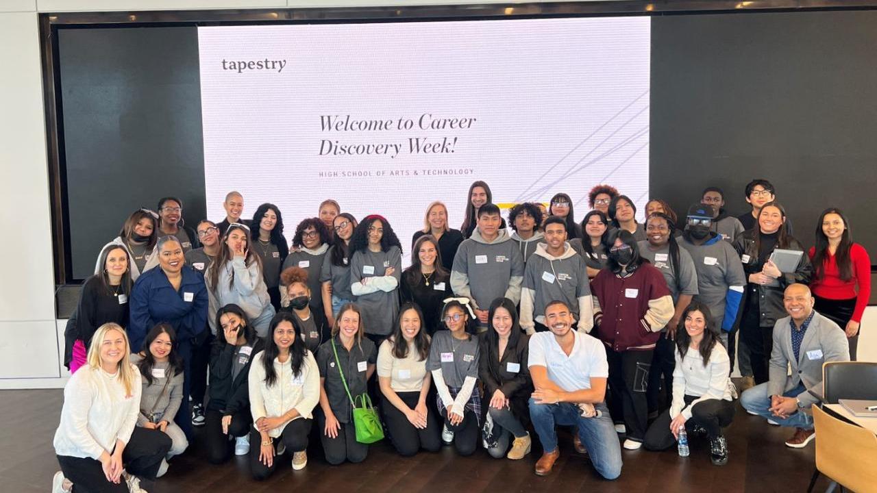A large group of people posed in front of a large digital display "Welcome to Career Discovery Week!"