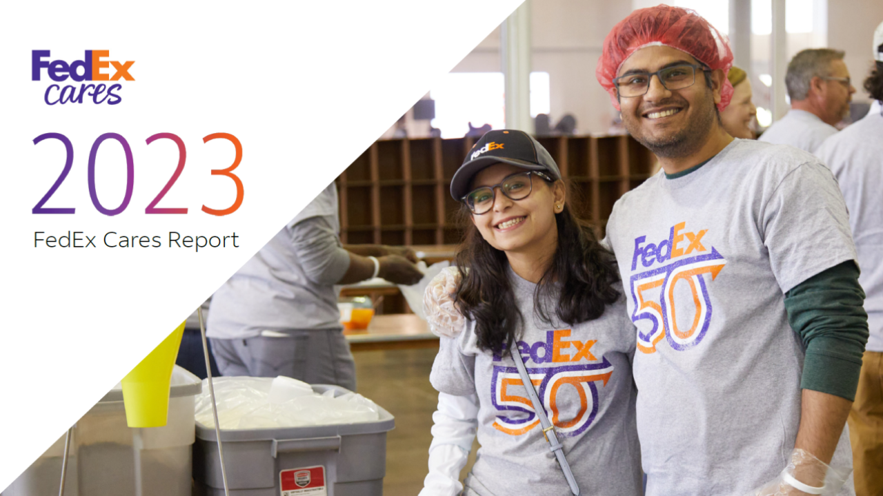 Two smiling people in "FedEx 50" t-shirts. "FedEx Cares 2023" on the side.