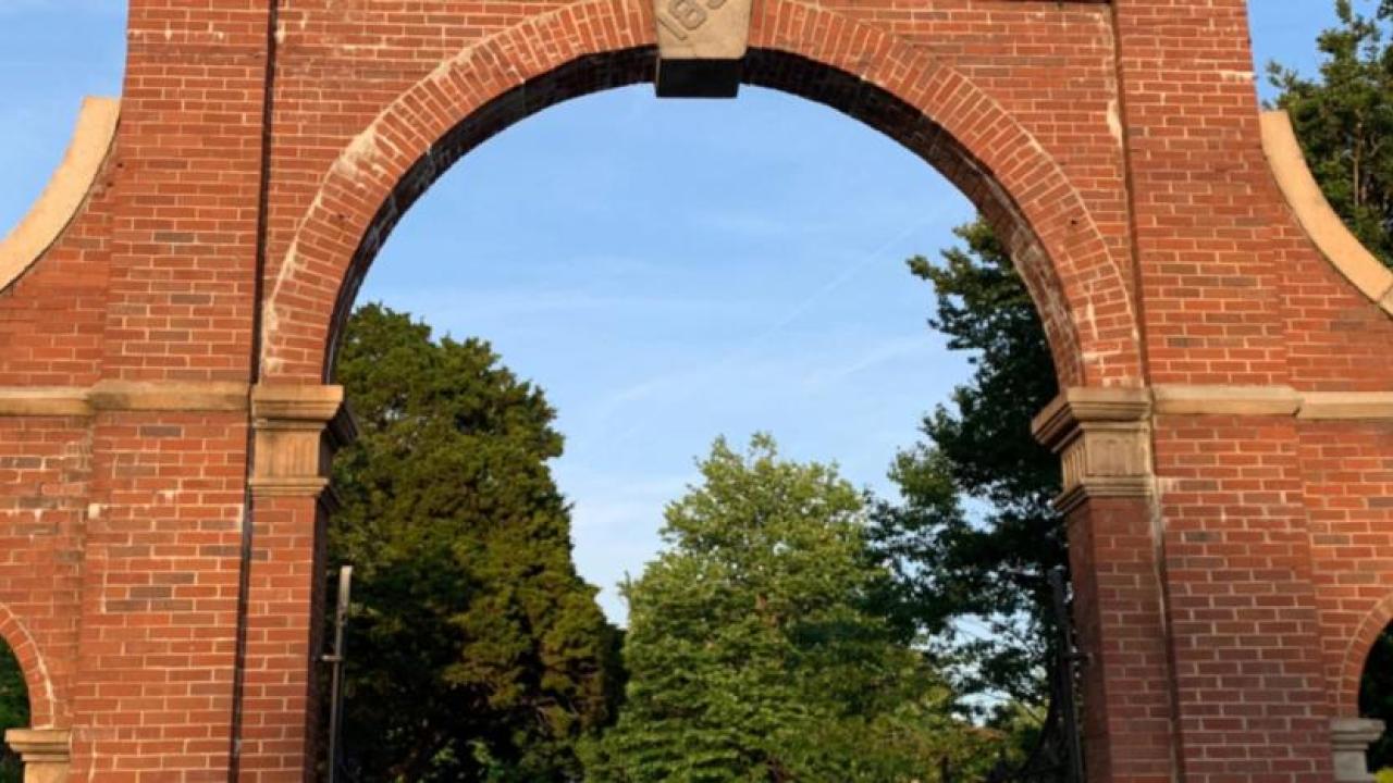 A tall brick archway entrance to the cemetary.