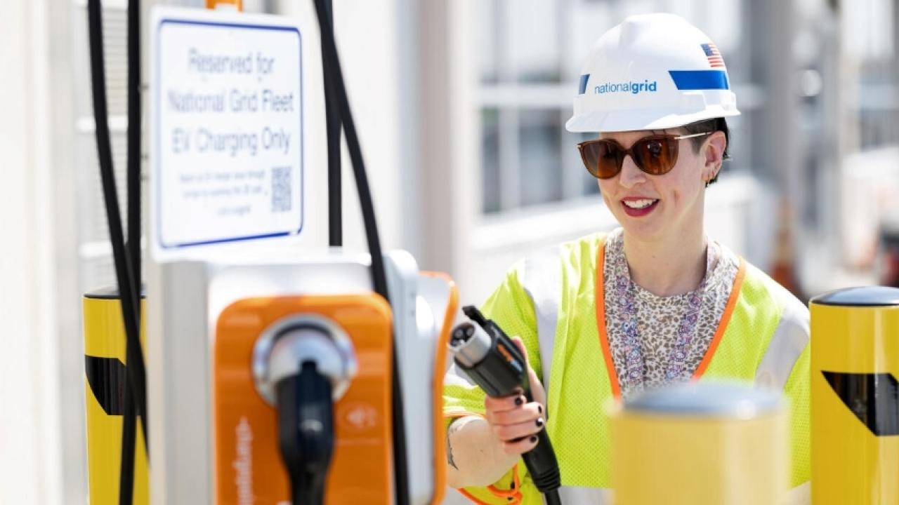 National Grid employee using an EV charger