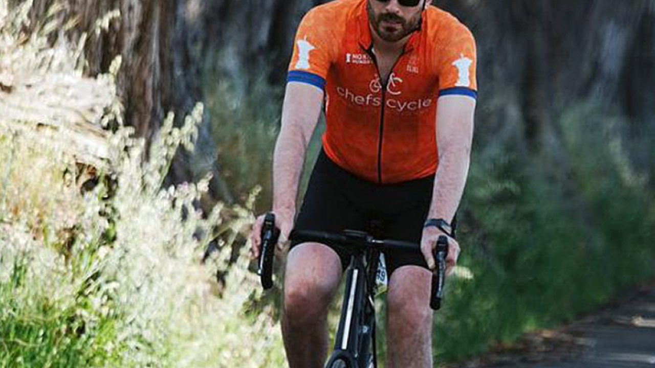 Man bicycling outdoors on a road