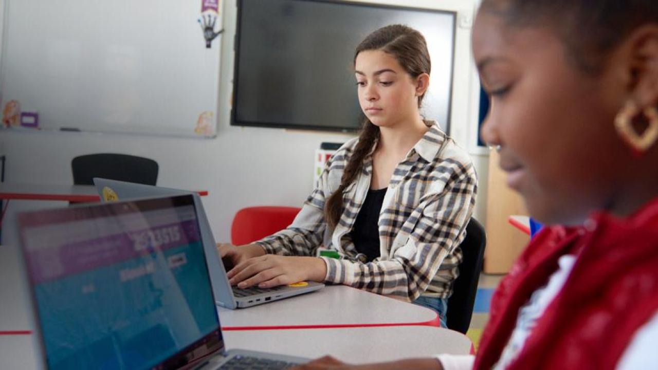 children working on laptops