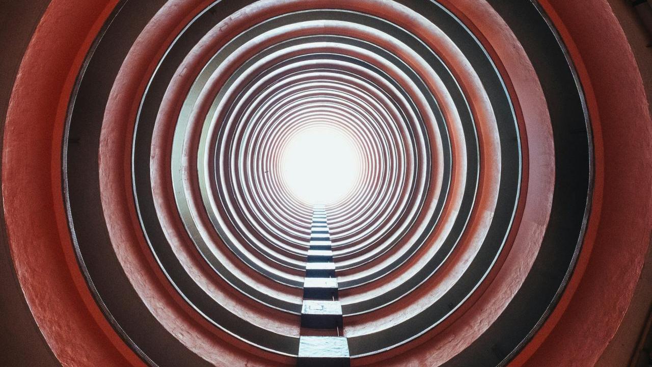 Looking through a long tunnel towards a bright light.